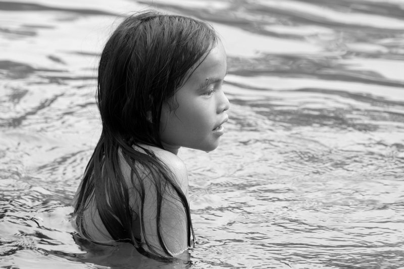 Girl swims in river